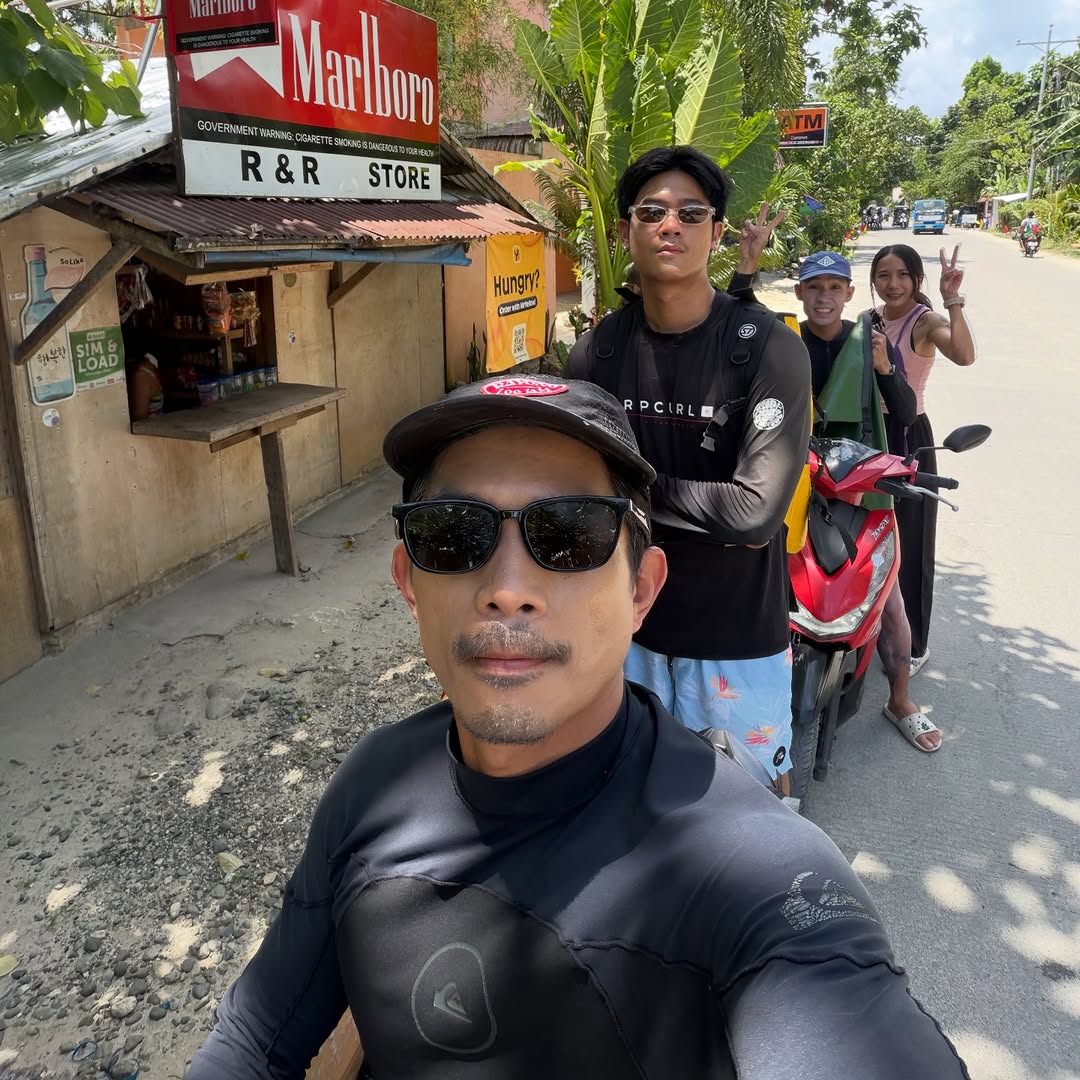 Surfers heading to the break on the road